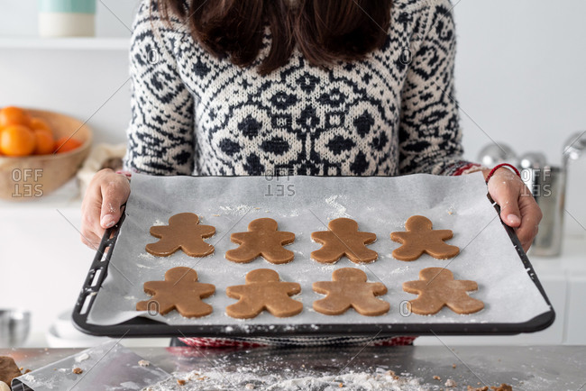 High angle close up of Gingerbread Men on a baking tray. Stock Photo by  Mint_Images