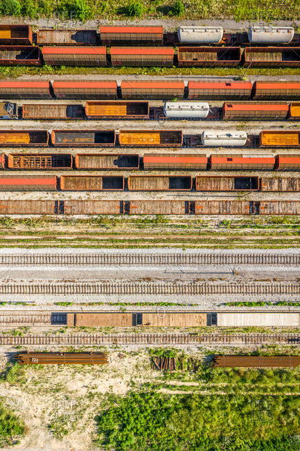 Aerial view of cargo trains stationed on rail tracks.