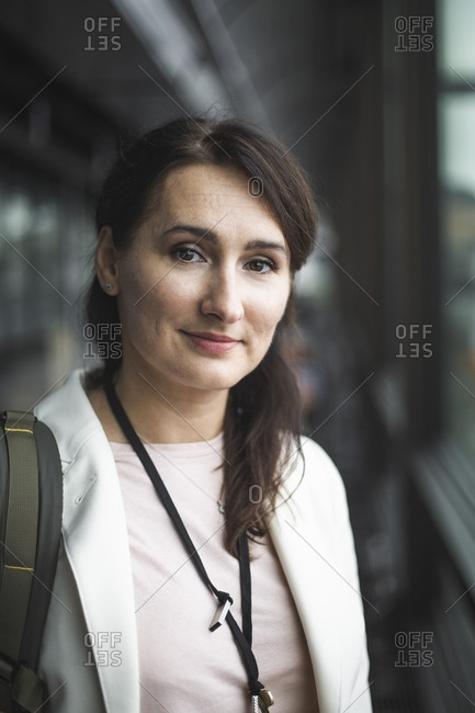 Portrait of female entrepreneur standing in office corridor
