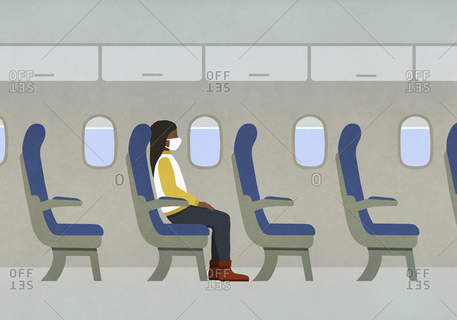Woman in face mask riding airplane alone