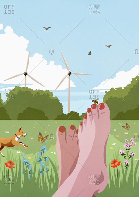 POV carefree barefoot woman relaxing in sunny, idyllic spring meadow with wind turbines