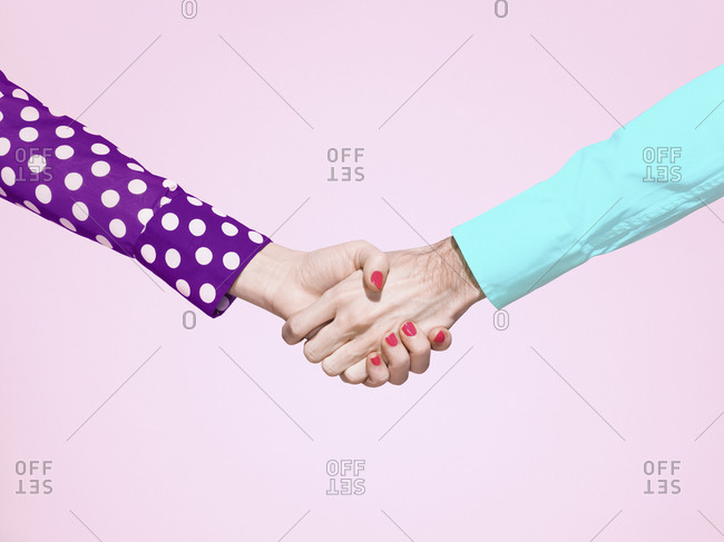 Vibrant handshake on pink background