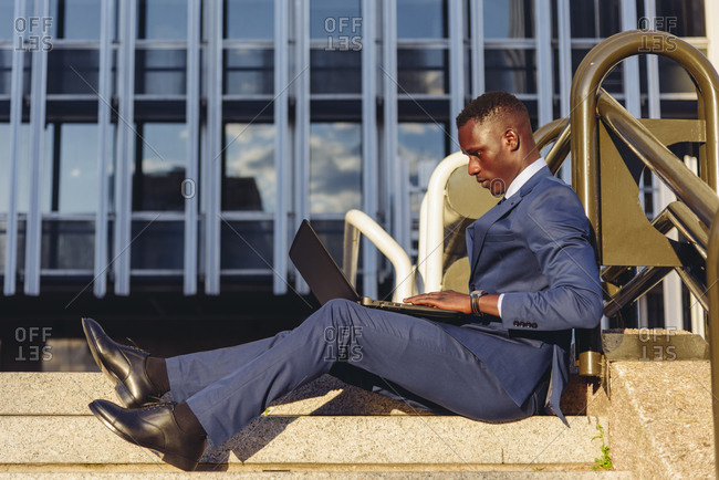 Full body side view of concentrated african american financial manager