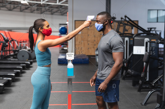 Caucasian man and african american woman dressed in activewear
