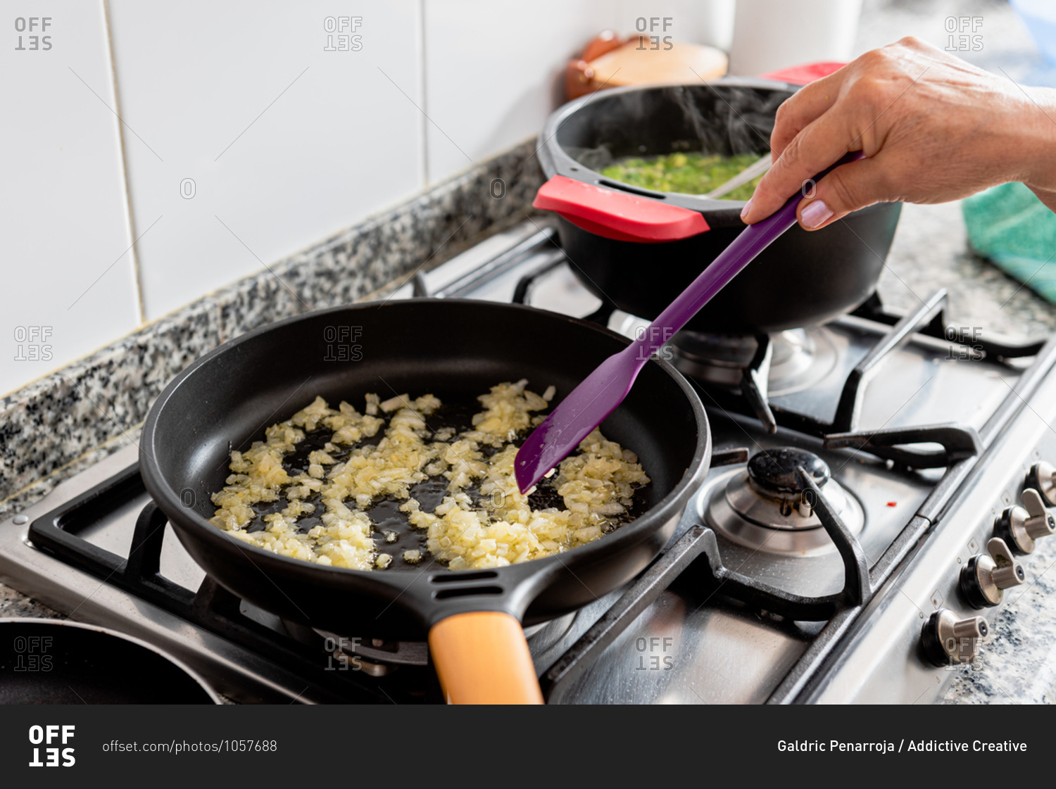 Crop anonymous woman frying red onion in hot pan with oil while preparing traditional catalan fish dish in home kitchen