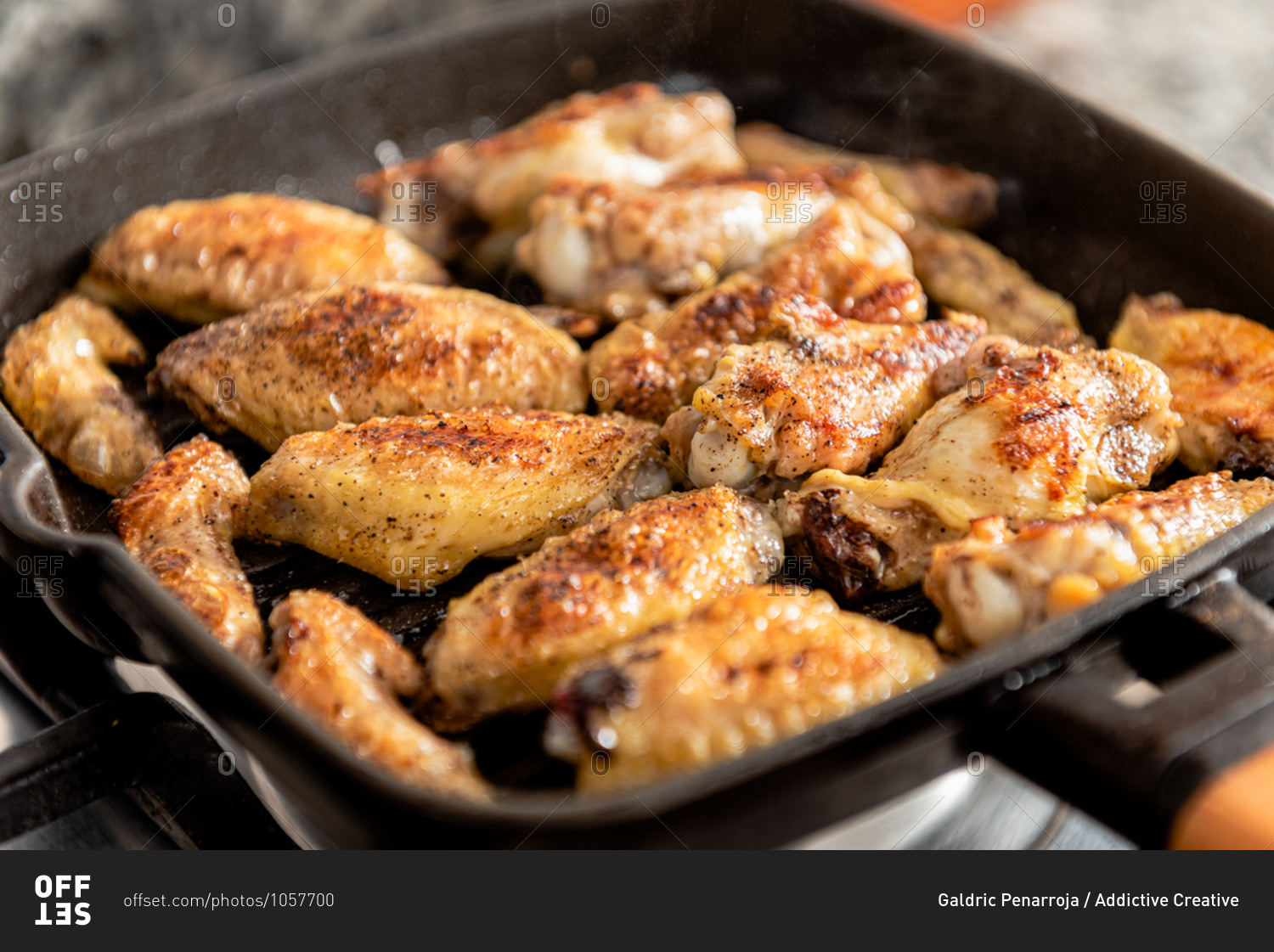 Closeup of hot freshly roasted chicken with appetizing crust in frying pan in kitchen