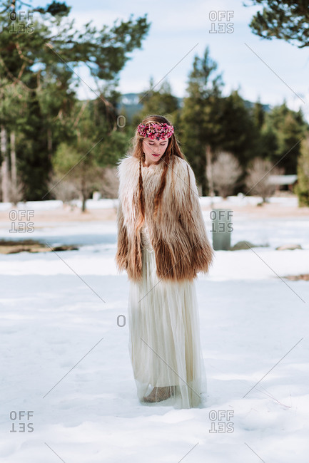 Full body of young blonde female in boho style wedding dress