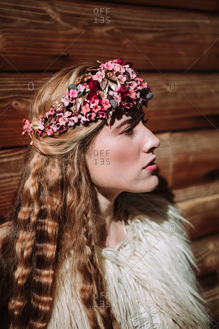 Charming confident nordic young female with long wavy blond hair