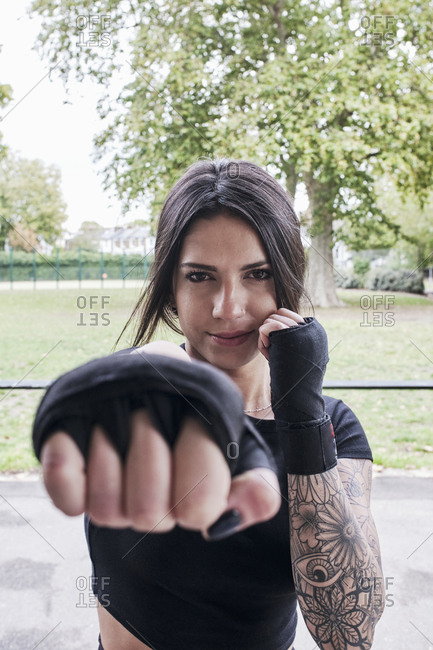 Portrait of a woman in boxing position with bandages on her hands.