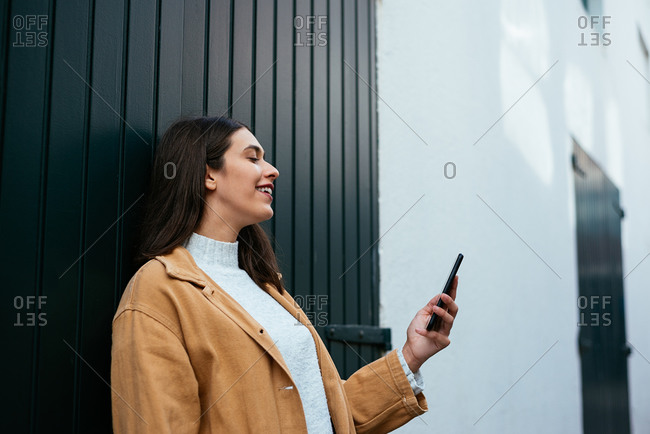 Woman standing on the street and using her smartphone