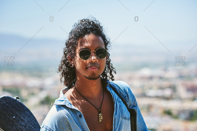 Portrait of young attractive man with dark skin. He is a musician from Latin America.