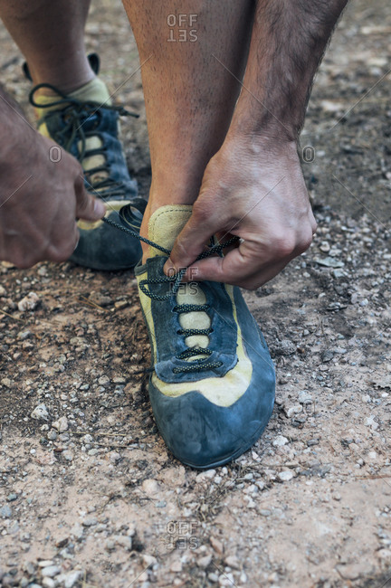 Tying the laces of climbing shoes.