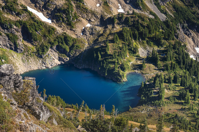 Blue alpine lake surrounded by green