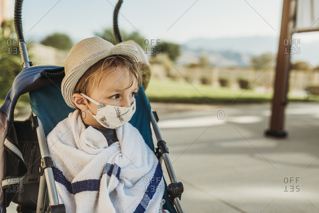 Portrait of young boy with mask on outside on vacation