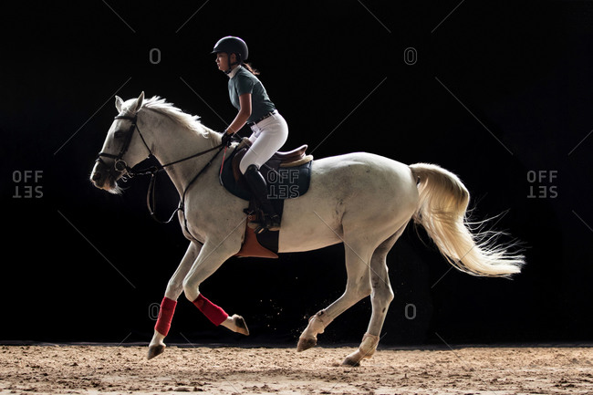Handsome girl riding a horse