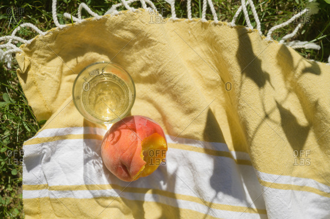 Peach juice on picnic blanket