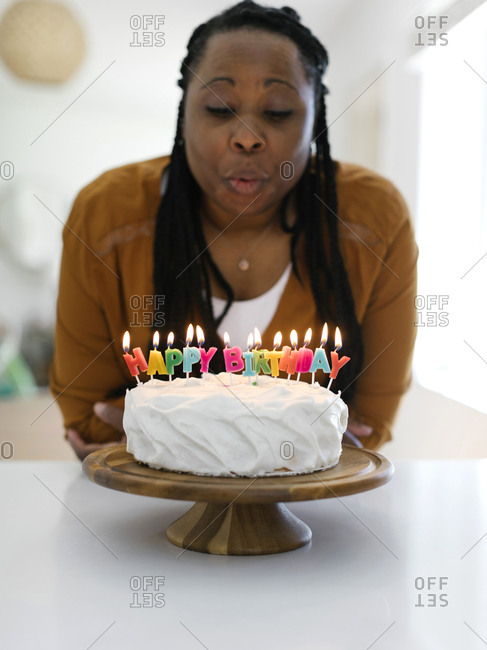 Boy about to blow candles out on birthday cake - Stock Image - F019/0773 -  Science Photo Library