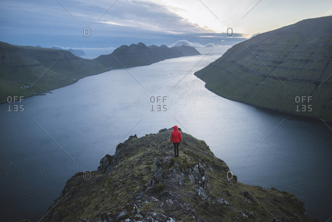 Denmark, Faroe Islands, Klaksvik, Woman standing on Klakkur mountain and looking at fjord