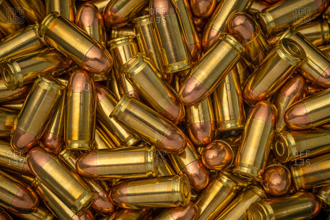 Heap Of Yellow Brass Gun Bullets Closeup Stock Photo, Picture and Royalty  Free Image. Image 129974413.