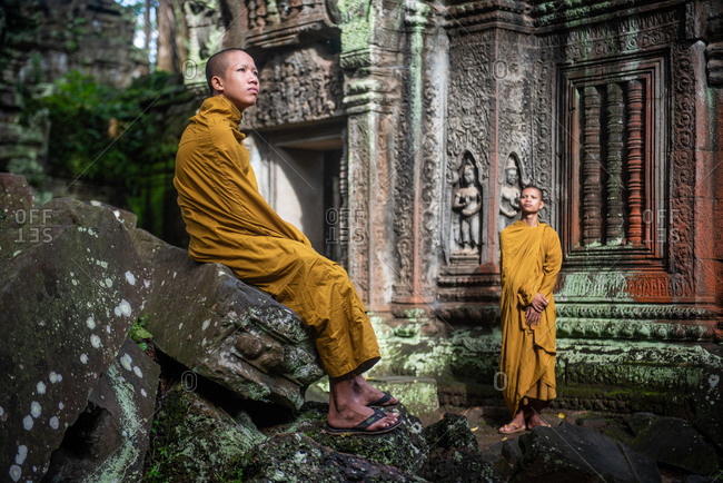 TA PROHM, ANGKORIAN TEMPLE, SIEM REAP, CAMBODIA - 28 October 2014: Monks appreciate temple environment.
