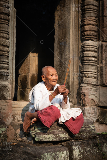 SIEM REAP, CAMBODIA - 17 March 2013: Nun praying at Preah Khan Temple, Angkor Park.
