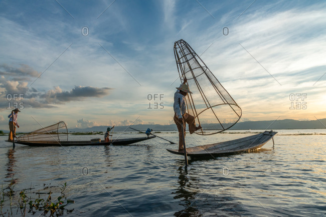 Inle Lake, Myanmar - 5 june 2012:  Fisherman using conical net at sunset.