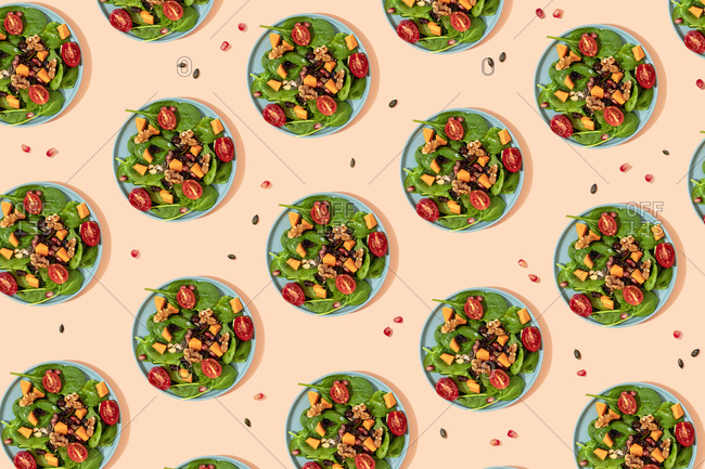 Pattern of plates of fresh ready-to-eat vegan salad