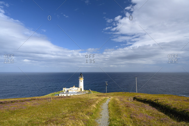 UK- Scotland- Tiumpan Head Lighthouse with clear line of horizon over sea in background