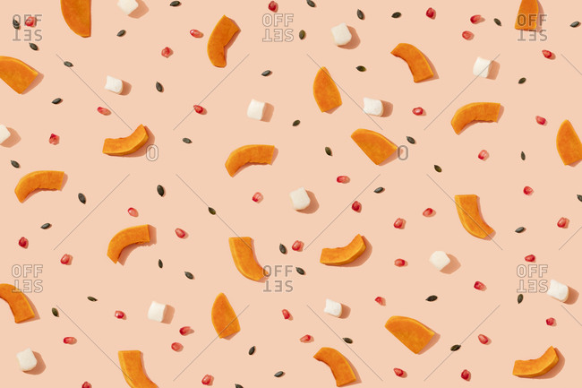 Pattern of pumpkin seeds- pomegranate seeds and pieces of cheese and pumpkin