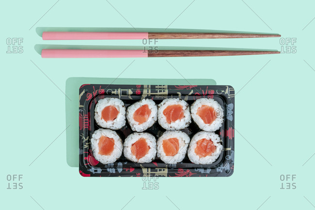 Sushi Set nigiri and sushi rolls on wooden serving board with soy sauce and  chopsticks over black stone texture background. Top view with space. Japan  menu Stock Photo