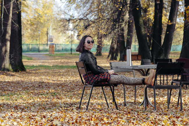 Smiling woman spending leisure time in public park