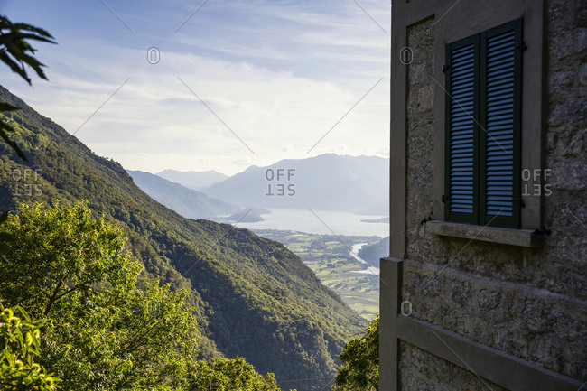 Italy- Province of Sondrio- Corner of building overlooking valley in Riserva Naturale Pian di Spagna e Lago di Mezzola