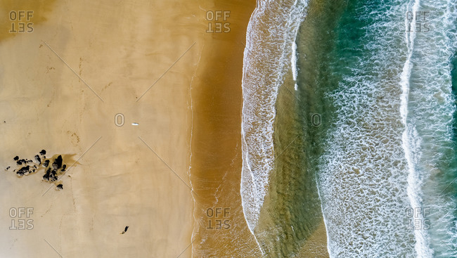 Aerial view of edge of sandy coastal beach