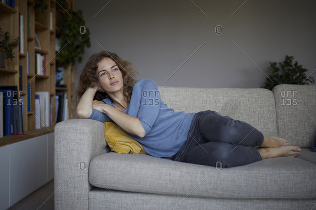 woman thinking sofa stock -