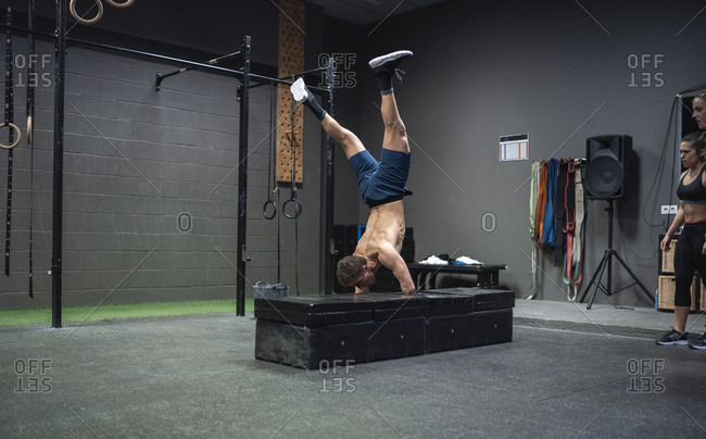 Adaptive athlete doing handstand while exercising at gym
