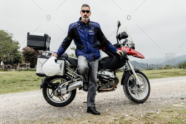 Motorcyclist standing next to his motorcycle. adventure concept