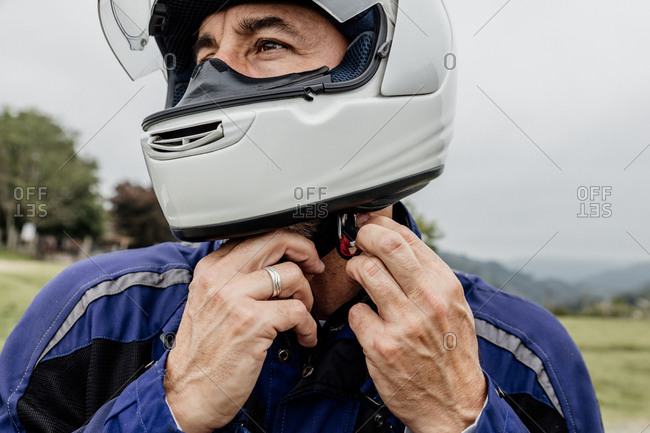 Motorcyclist putting on his helmet to ride. adventure concept