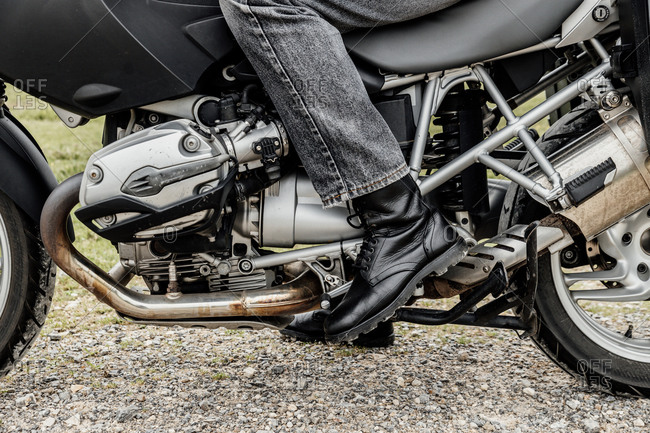 Close-up of a foot in boots doing gear shifts on a motorcycle