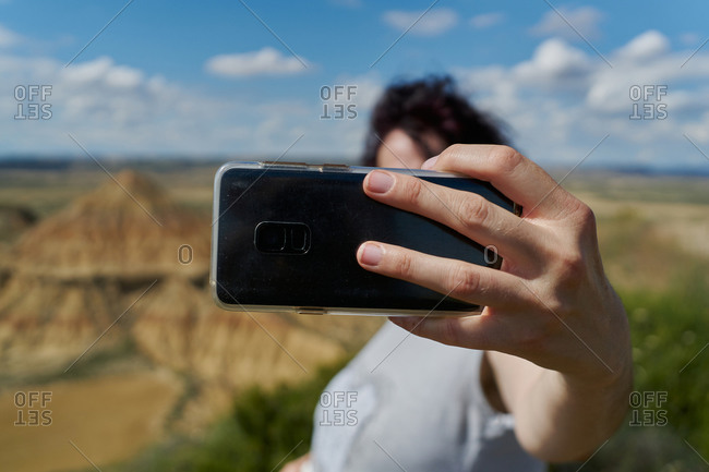 A woman makes a selfie with her mobile phone in the Bardenas Reales desert in Spain