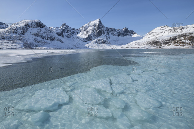 Clear water covers icy bay at Flakstadpollen, Flakstadoy, Lofoten Islands, Norway