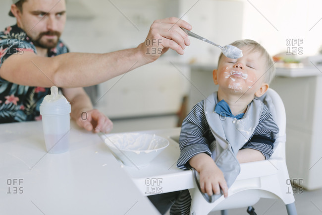 Father feeding toddler son from the Offset collection