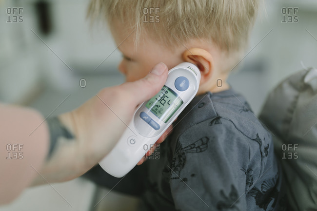 Mother checking toddler temperature from the Offset collection