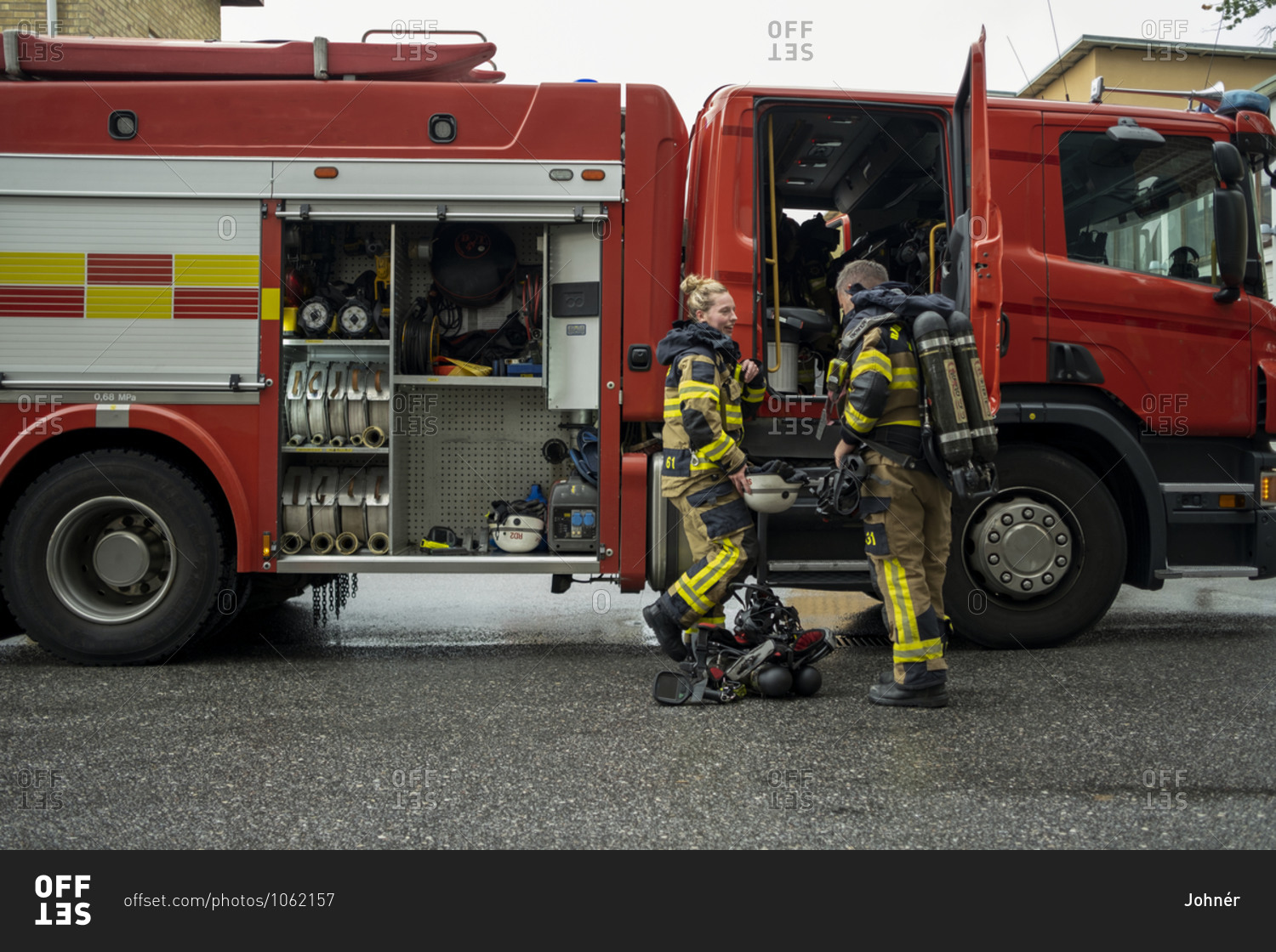 Firefighters in front of fire engine
