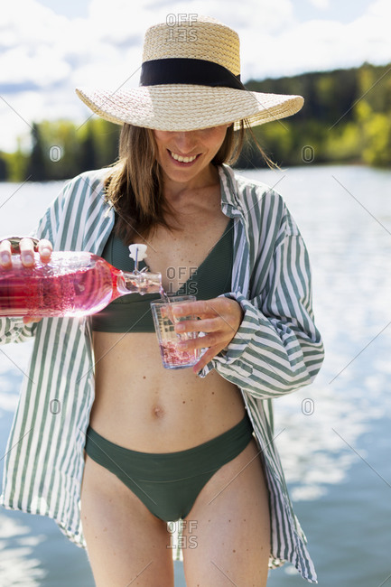 Woman pouring drink into drinking glass
