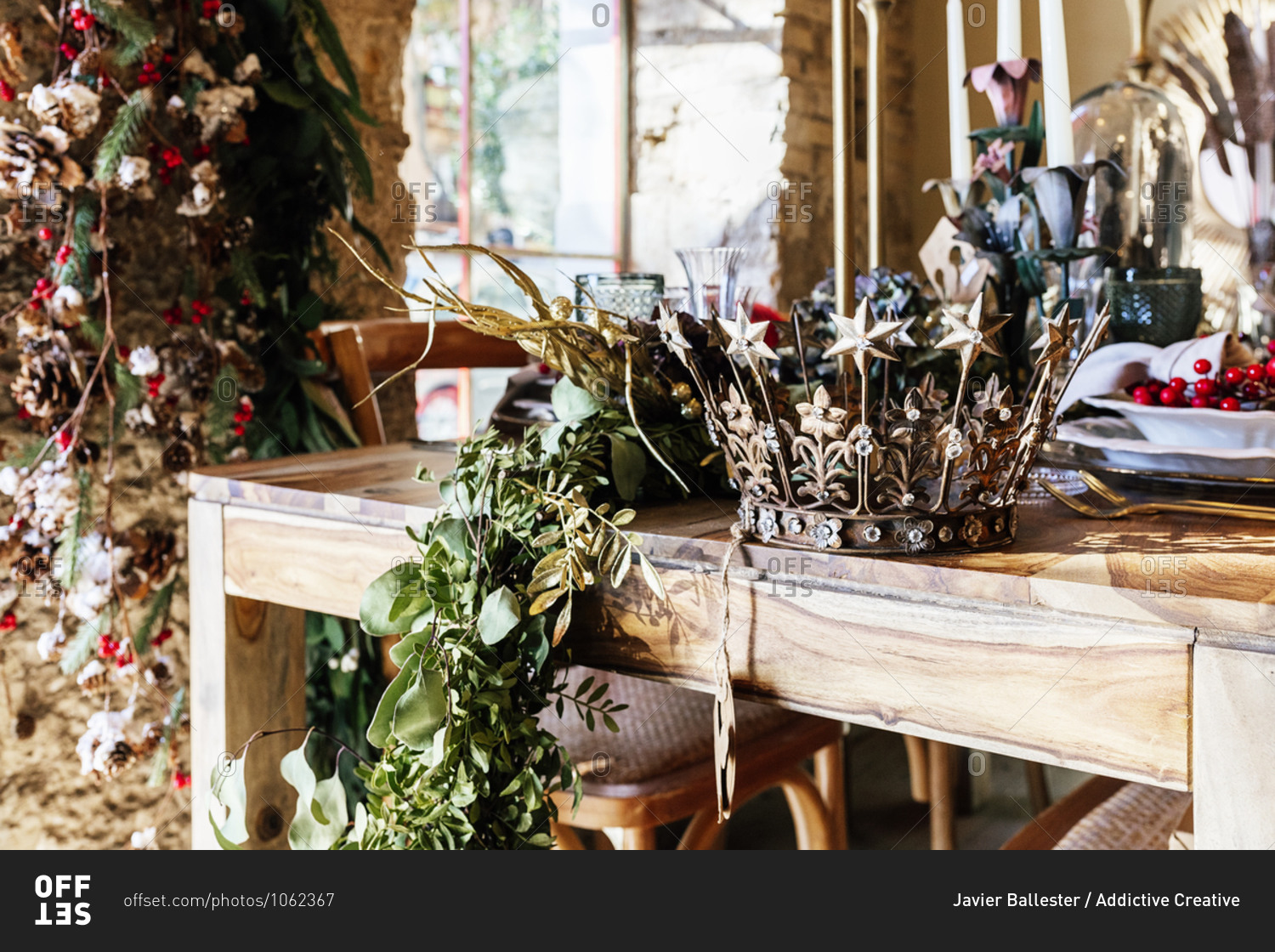 Decorative vintage crown and leaves on wooden table in decor shop during Christmas season