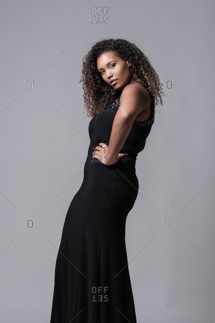 Plus size cheerful African American female model with long curly