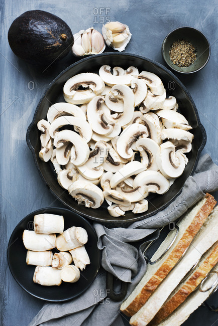 Sliced raw mushrooms in a cast iron pan