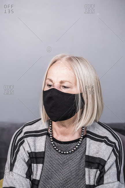 Senior woman wearing a black facemask during a pandemic