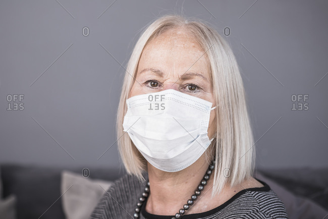 Senior woman wearing a white facemask during a pandemic