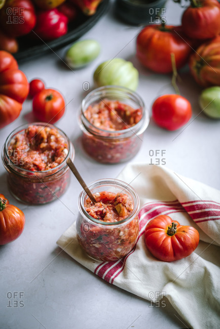 Elevated view of homemade salsa prepared in glass jars